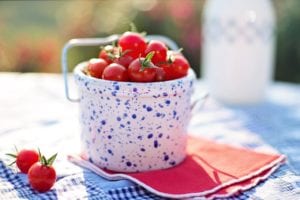 A cherry tomato will grow faster and better in the heat than a large variety.